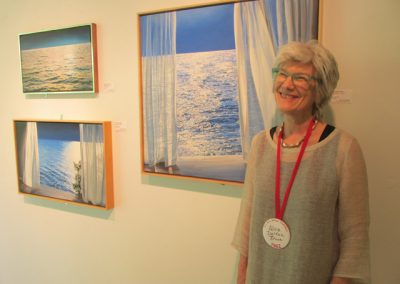 Alice Dalton Brown with her paintings